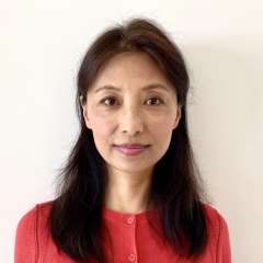 headshot of Lucy Shah in red sweater