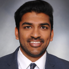 Head shot of Rohan Rao in business attire, smiling at camera