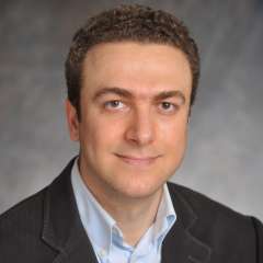 Cancer reseacher Dr. Aydogan Ozcan smiling and looking at the camera