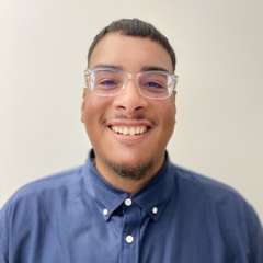 headshot of Matt Morales wearing glasses and a blue button down shirt 