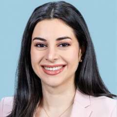 Head shot of Natalie Nabaty in business attire, smiling at the camera