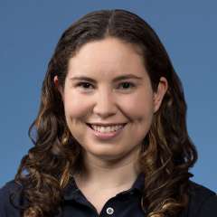 Headshot of Rebecca Altman wearing a UCLA Health polo shirt against a blue background.