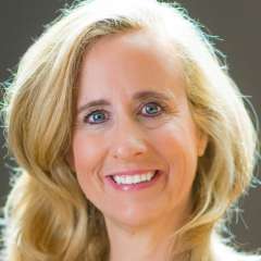 Dr. Melissa Brymer, smiling with long blonde hair wearing a light-colored top.