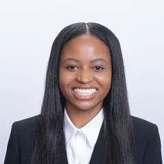 Head shot of Christina Ramsey in business attire, smiling at camera