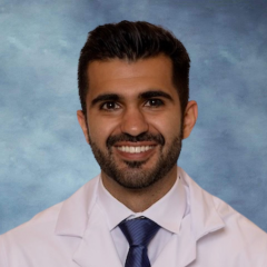 headshot of Dr. Edward Mezian in front of a blue background
