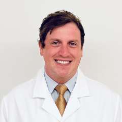 Dr. Worden wearing a white coat