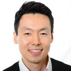 headshot of Dr. Alexander Sun in black suit