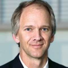 headshot of Dr. Shekelle in black suit