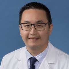 Headshot of Eric Y. Lee, DPM, wearing a white coat and a tie.
