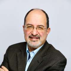 Professional photo of Dr. Arash Naeim wearing a suit and tie