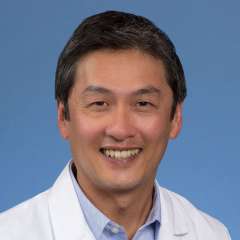 Steven Tan, MD in white coat against blue background