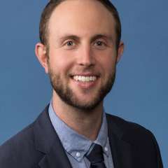 headshot of Marc J. Weintraub, PhD in an indoor setting in front of a blue background