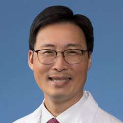 Michael W. Yeh, MD, in a white coat and tie.