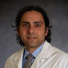 Boback Ziaeian, MD, PhD headshot wearing a white coat and tie