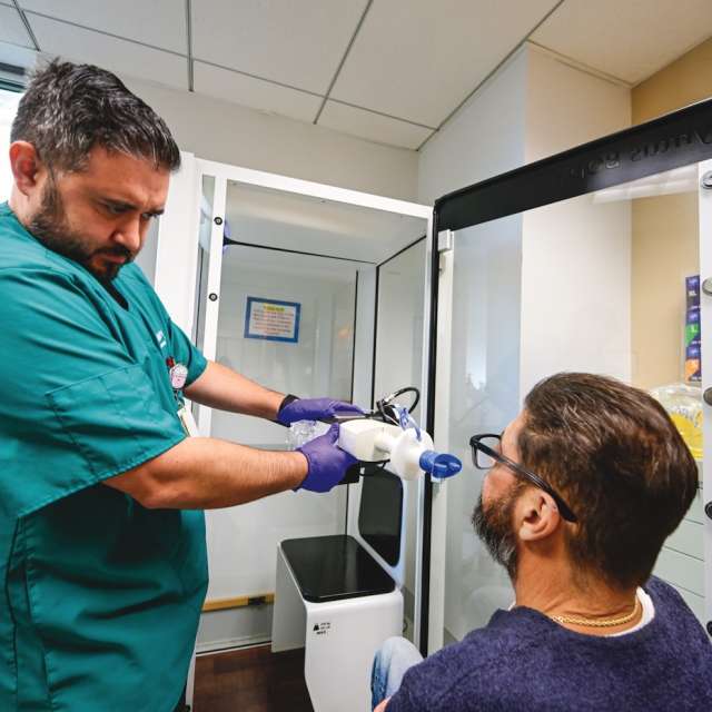 Respiratory therapist checks patient lung function