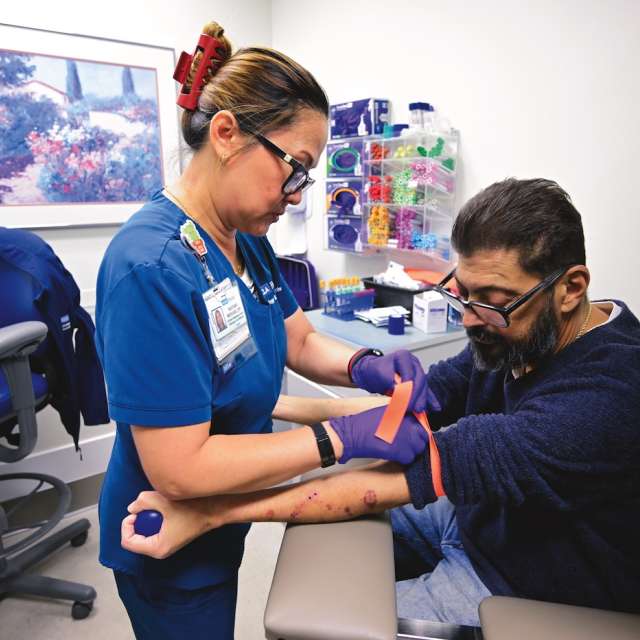 UCLA Health nurse taking blood from patient