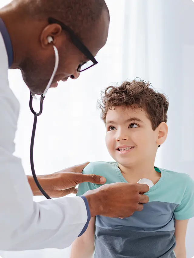 Doctor examining a child with a stethoscope.