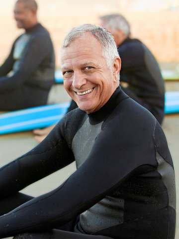 Older male surfer on beach